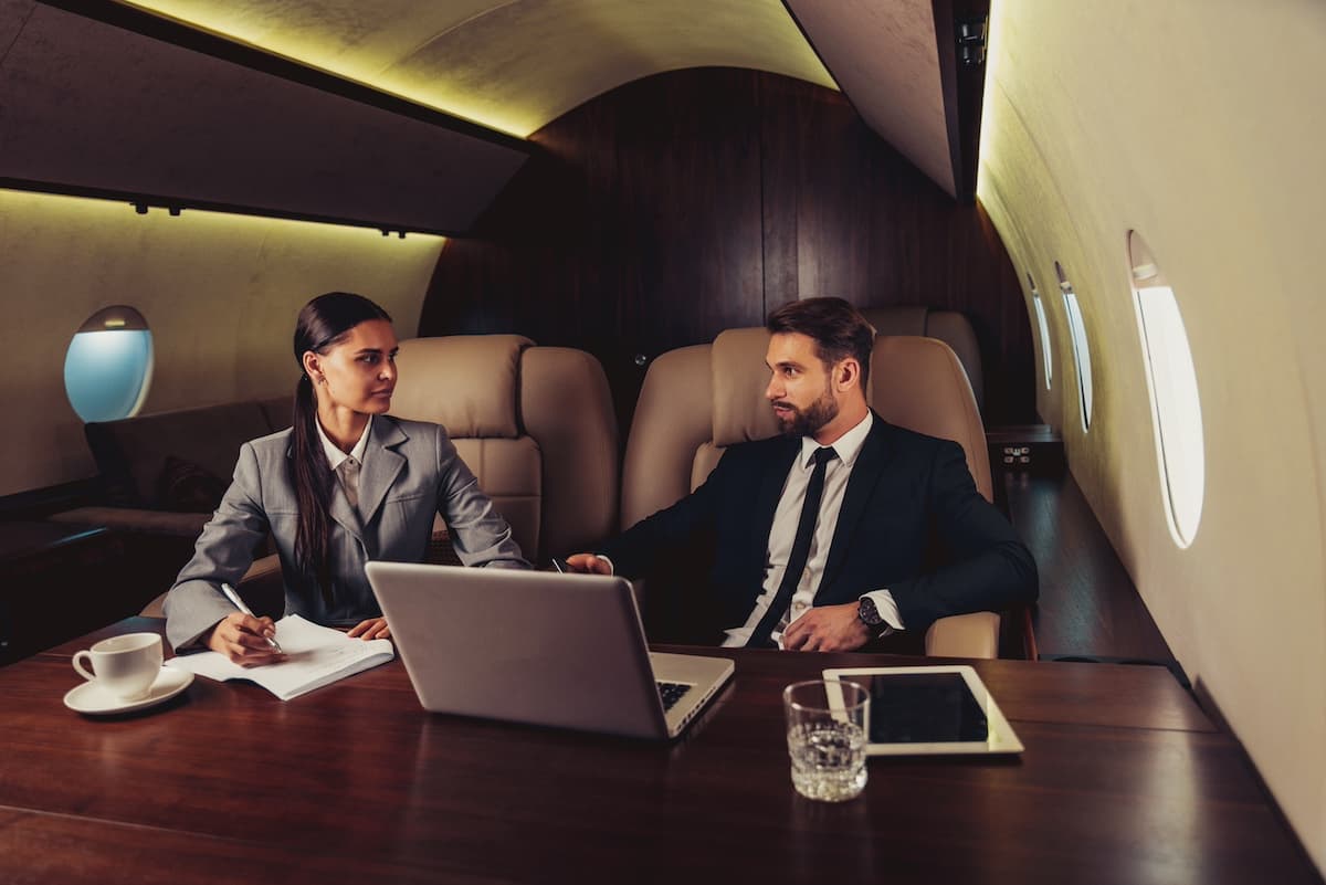 Man and woman on a private jet for corporate travel