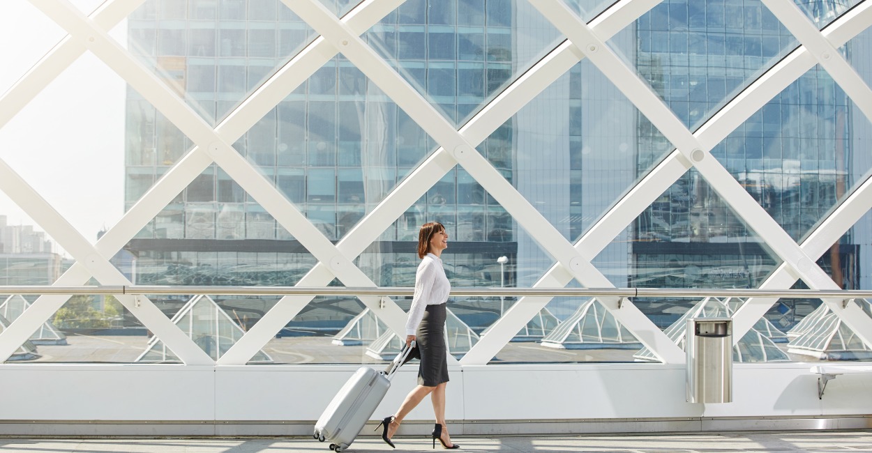 Business woman walking with her luggage