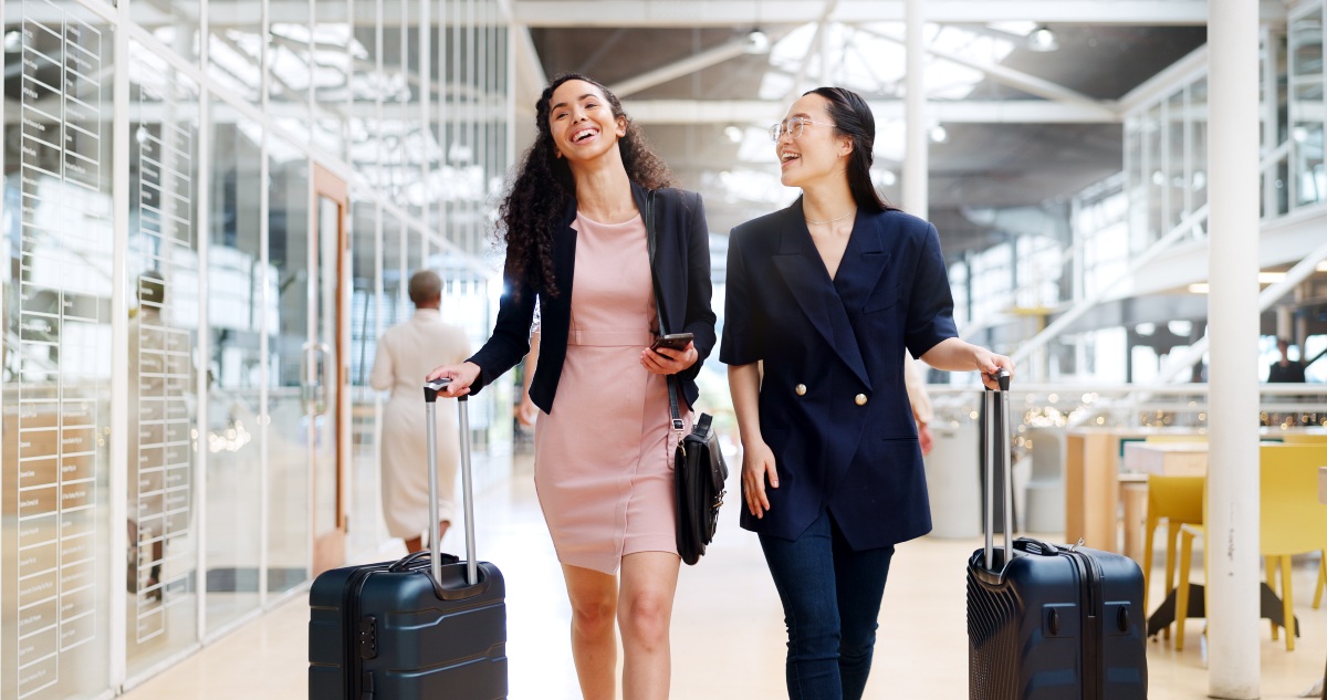 Businesswomen walking with luggage on a business travel trip